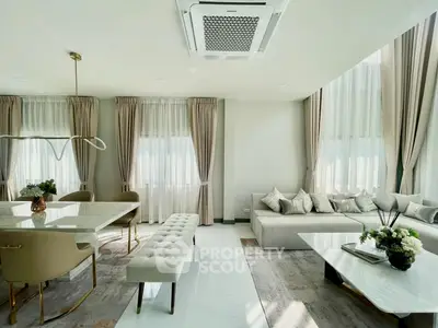 Luxurious living room with elegant decor, featuring a spacious seating area and stylish dining setup.