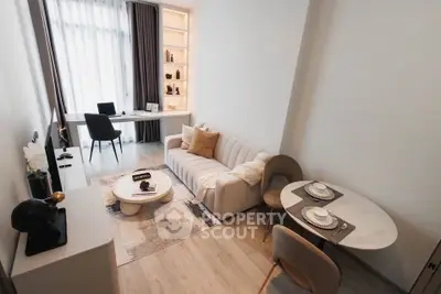 Modern living room with stylish furniture and natural light, featuring a cozy sofa and elegant dining area.