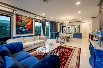Luxurious living room with elegant decor, plush blue sofas, and vibrant artwork, perfect for modern living.