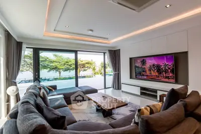 Luxurious living room with modern decor and large windows offering stunning outdoor views.