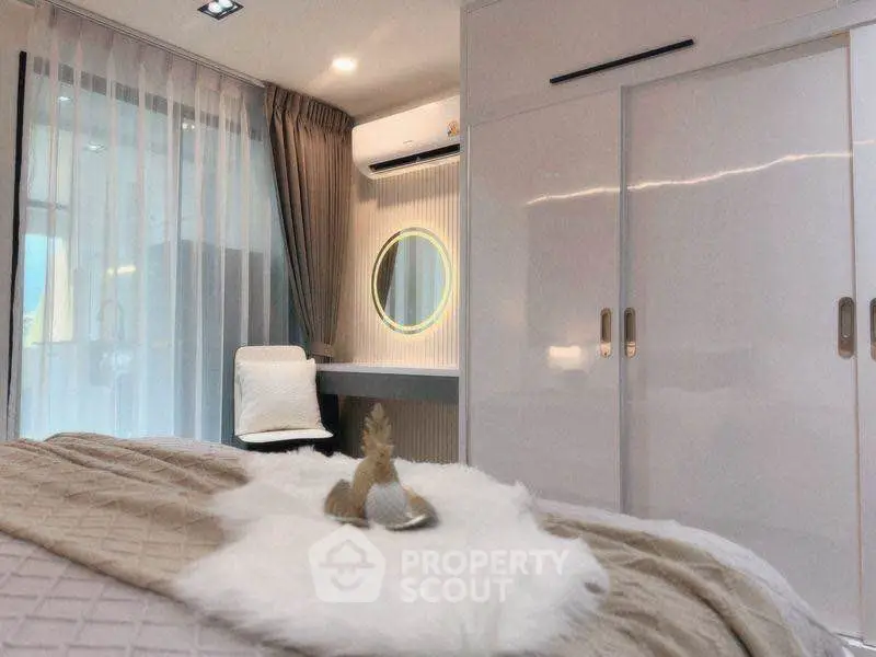Modern bedroom with stylish decor and built-in wardrobe, featuring a cozy ambiance.