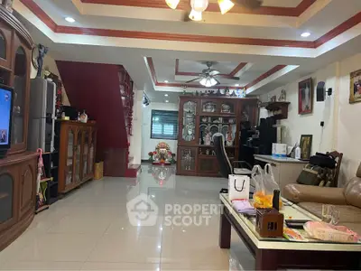 Spacious living room with elegant wooden furniture and modern decor, perfect for family gatherings.