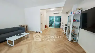 Spacious living room with modern decor and wooden flooring