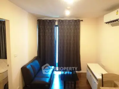 Cozy living room with dark curtains and modern furniture in a stylish apartment.