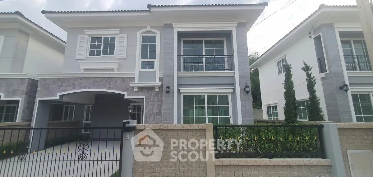 Elegant modern two-story house with large windows and stylish facade