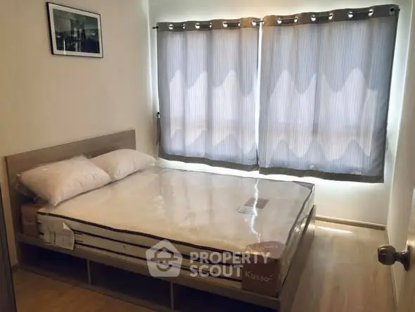 Cozy bedroom with natural light and modern decor, featuring a comfortable bed and stylish window treatments.