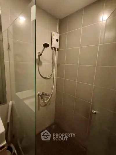 Modern bathroom with glass shower enclosure and sleek tile design