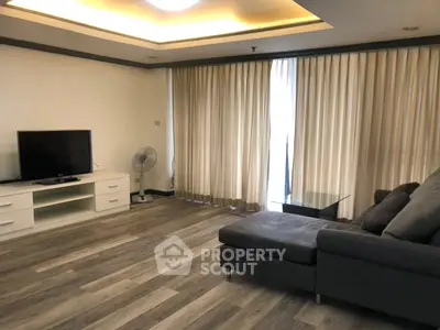 Spacious living room with modern decor and large windows for natural light.