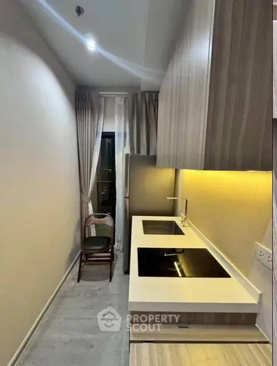 Modern compact kitchen with sleek design and induction cooktop
