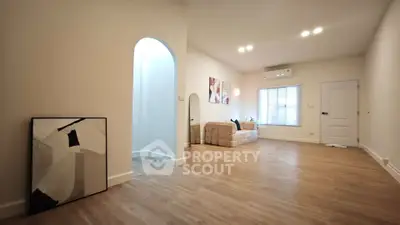 Spacious modern living room with stylish decor and wooden flooring