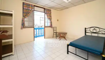 Spacious bedroom with balcony access and minimalist furnishings