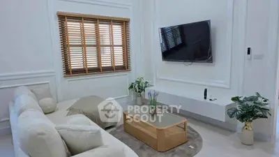 Elegant living room with modern decor and wall-mounted TV