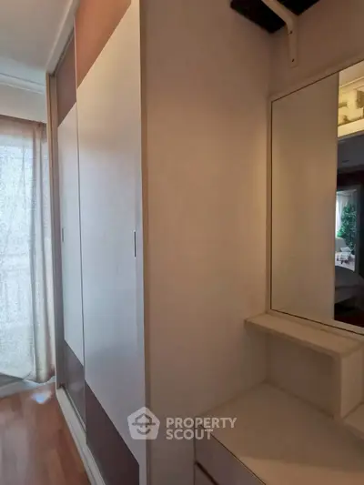 Modern bedroom with sleek wardrobe and natural light