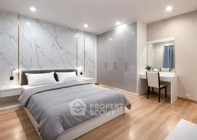 Luxurious modern bedroom with elegant marble accent wall and sleek furnishings.