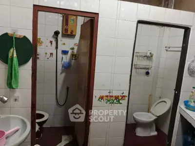 Functional bathroom with shower and toilet, ideal for compact living spaces.