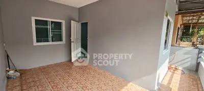 Spacious tiled patio with open door leading to interior, perfect for relaxation.