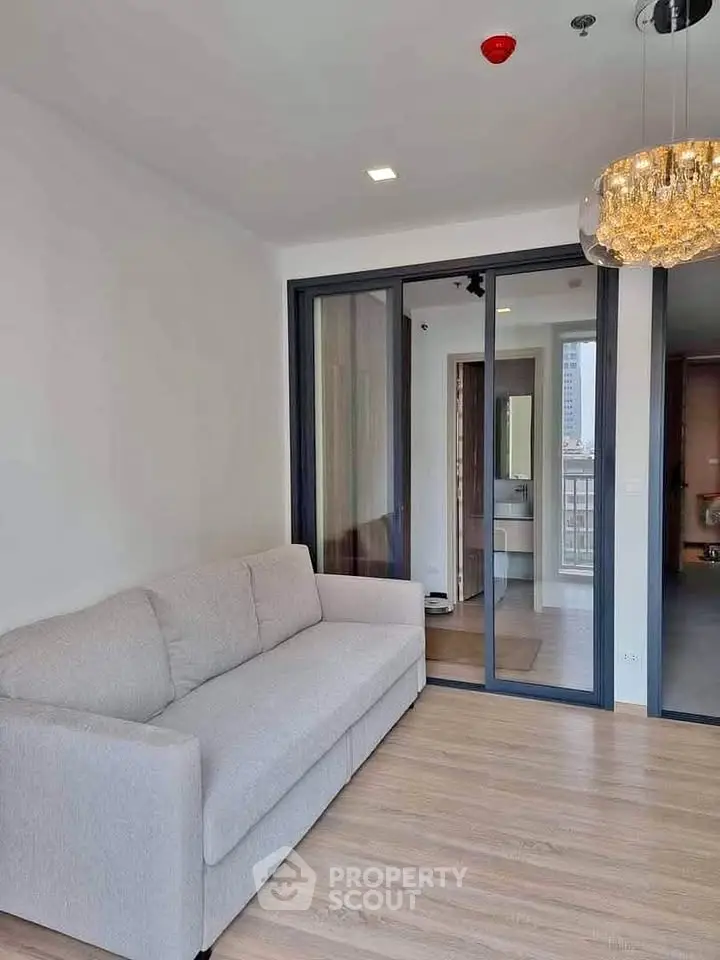 Modern living room with cozy sofa and elegant lighting in a stylish apartment.