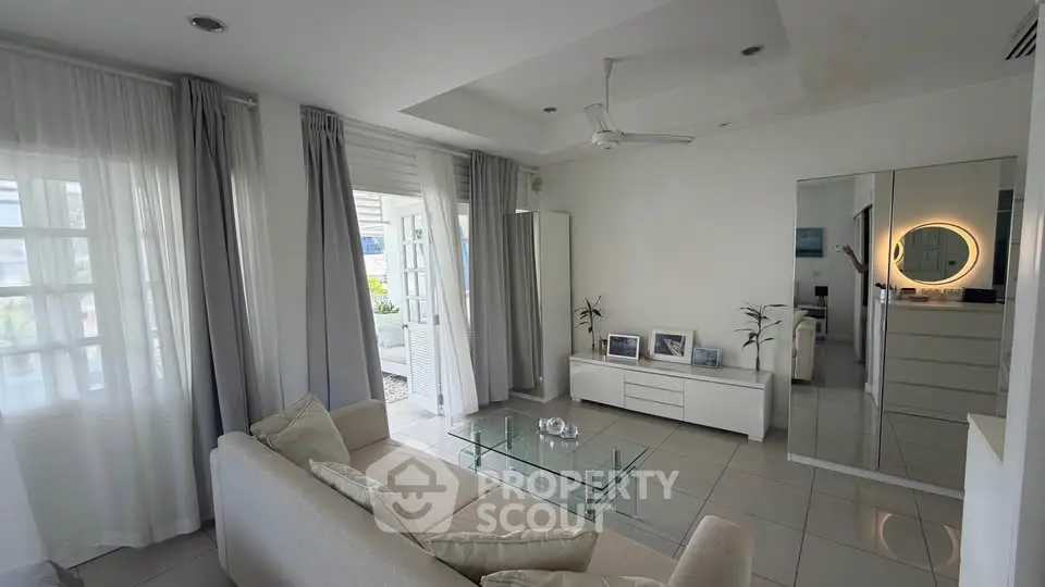 Spacious modern living room with glass coffee table and elegant decor
