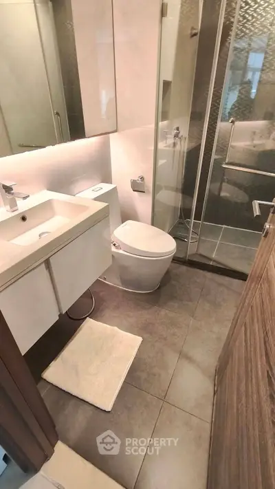 Modern bathroom with sleek fixtures and glass shower enclosure