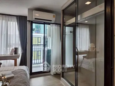Modern bedroom with balcony access and mirrored wardrobe in stylish apartment.