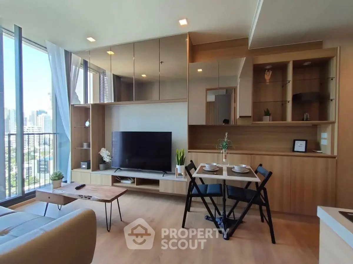 Modern living room with city view, stylish furniture, and natural light.