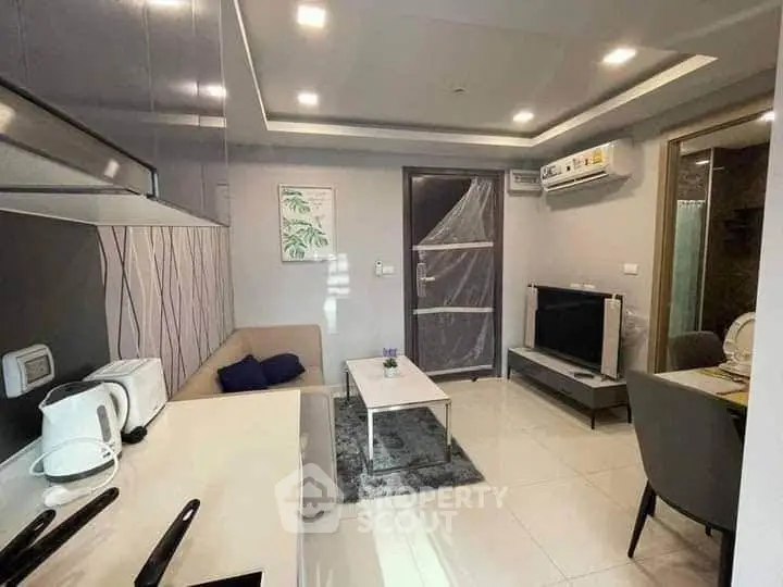 Modern living room with sleek furniture and integrated kitchen appliances
