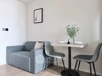 Modern living room with cozy gray sofa and stylish dining area, perfect for urban living.