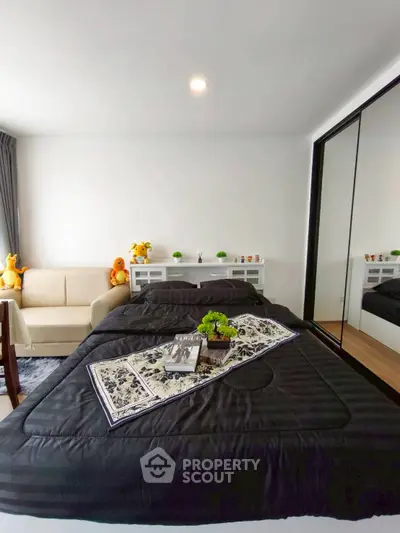 Modern bedroom with cozy decor and mirrored wardrobe