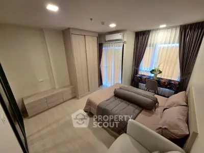 Modern bedroom with stylish decor and ample natural light