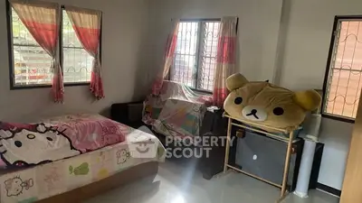 Cozy bedroom with playful decor and ample natural light