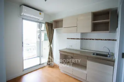 Modern kitchen with open layout and balcony access in a bright apartment