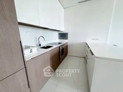 Modern kitchen with sleek cabinetry and built-in appliances in a minimalist design.