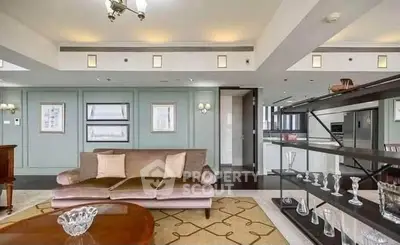 Luxurious living room with elegant decor and open kitchen layout in modern apartment.