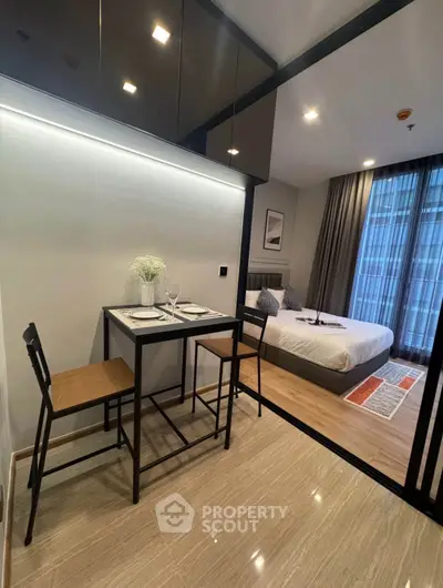 Modern studio apartment with cozy dining area and stylish bedroom