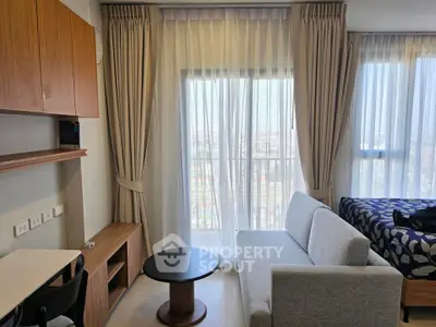 Modern living room with stylish furniture and large windows offering a bright and airy atmosphere.