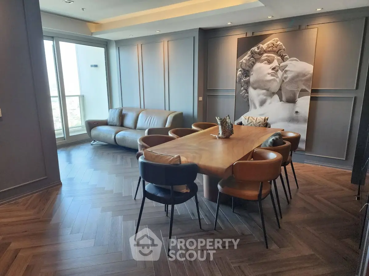 Luxurious modern living room with elegant dining area and stunning wall art, featuring sleek furniture and natural light.