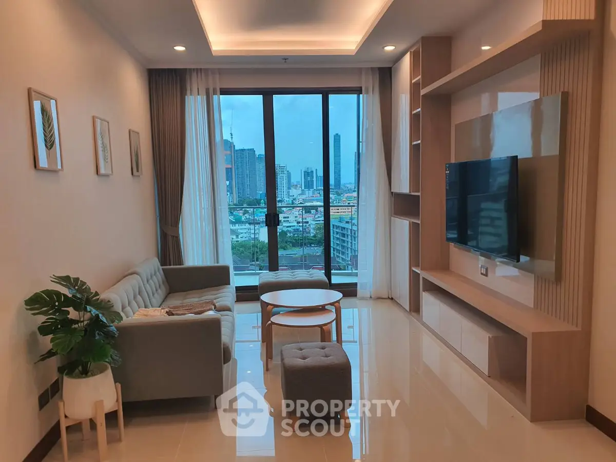 Modern living room with city view, stylish furniture, and large windows in a high-rise apartment.