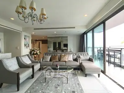 Spacious living room with elegant decor and large balcony access