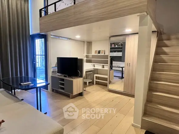 Modern loft apartment with mezzanine, stylish living area, and sleek wooden finishes.