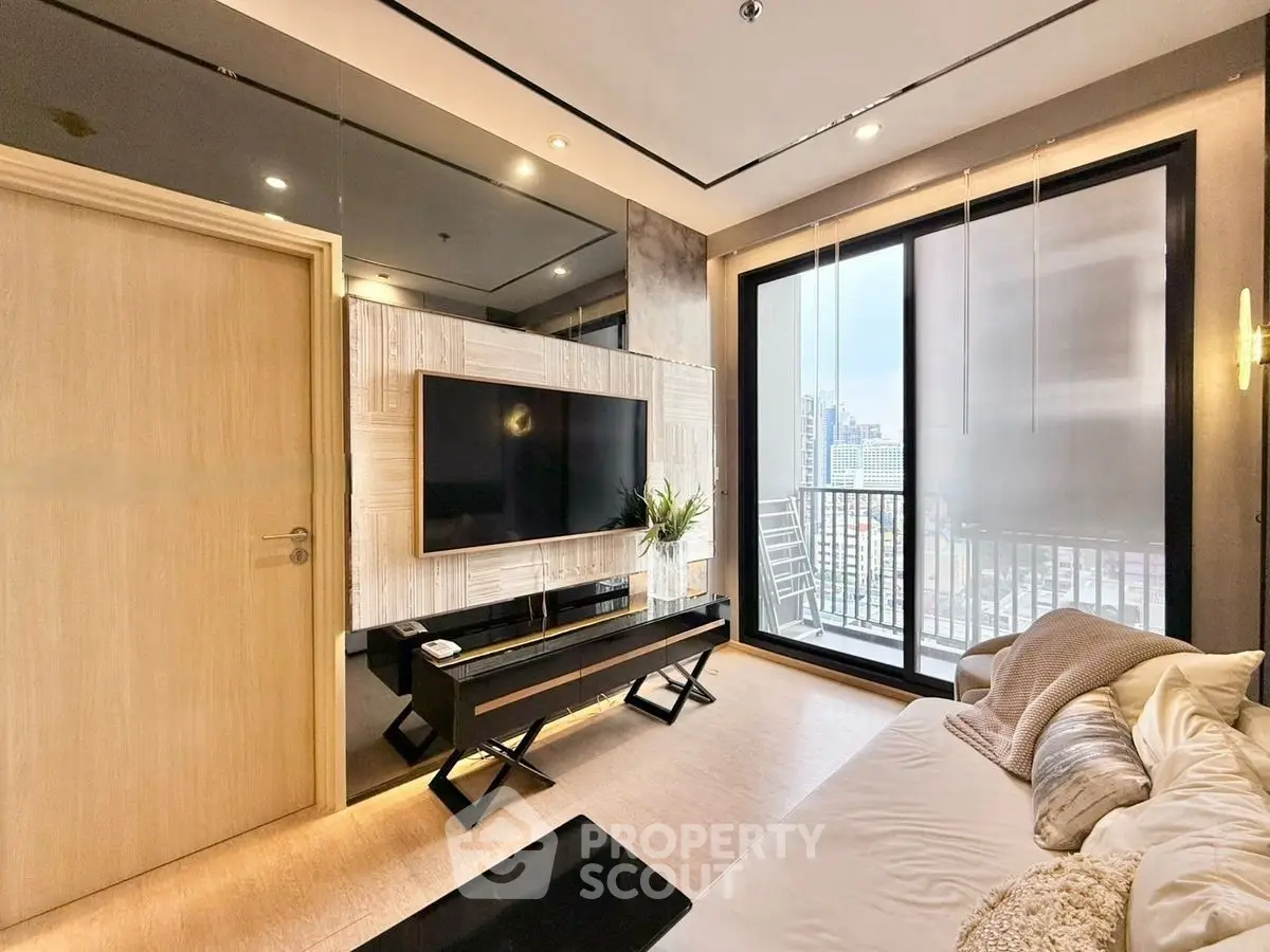 Modern living room with balcony and city view, featuring sleek TV setup and cozy seating.