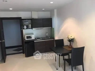 Modern compact kitchen with dining area in stylish apartment