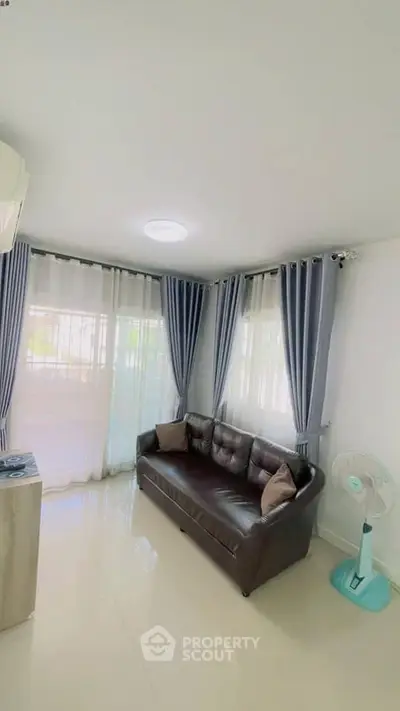 Bright living room with modern sofa and elegant curtains