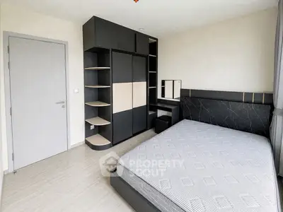 Modern bedroom with sleek black wardrobe and stylish bed design