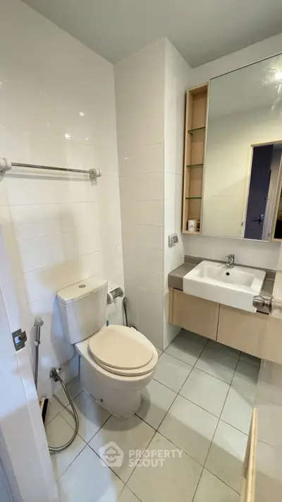 Modern bathroom with sleek fixtures and ample storage space.