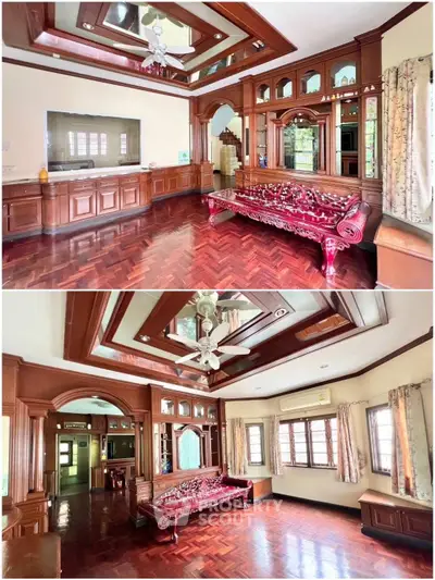 Elegant living room with wooden accents and large windows, featuring a traditional carved wooden sofa and polished floors.