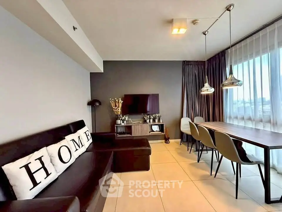 Modern living room with sleek furniture and large window view