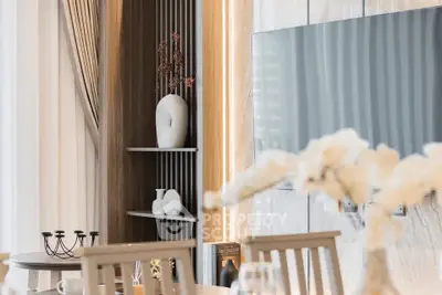 Elegant modern living room with stylish decor and large flat-screen TV, perfect for luxury living.