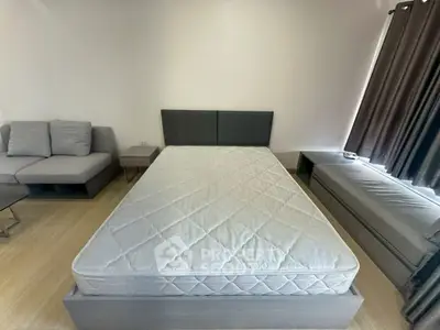 Modern bedroom with stylish bed and cozy seating area, perfect for relaxation and comfort.