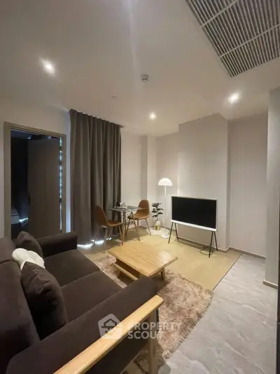 Modern living room with cozy seating and stylish decor in a contemporary apartment.