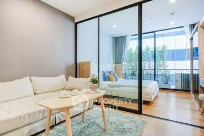 Modern studio apartment with glass partition and cozy decor